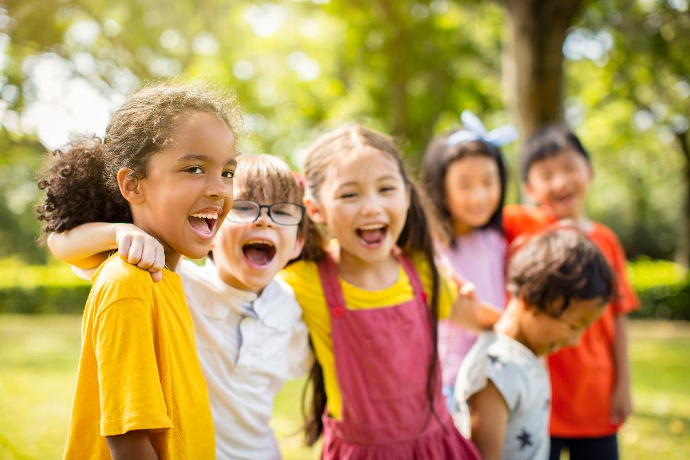 group of children hugging | family dentist garland tx