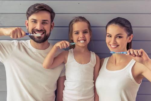 Family brushing their teeth together
