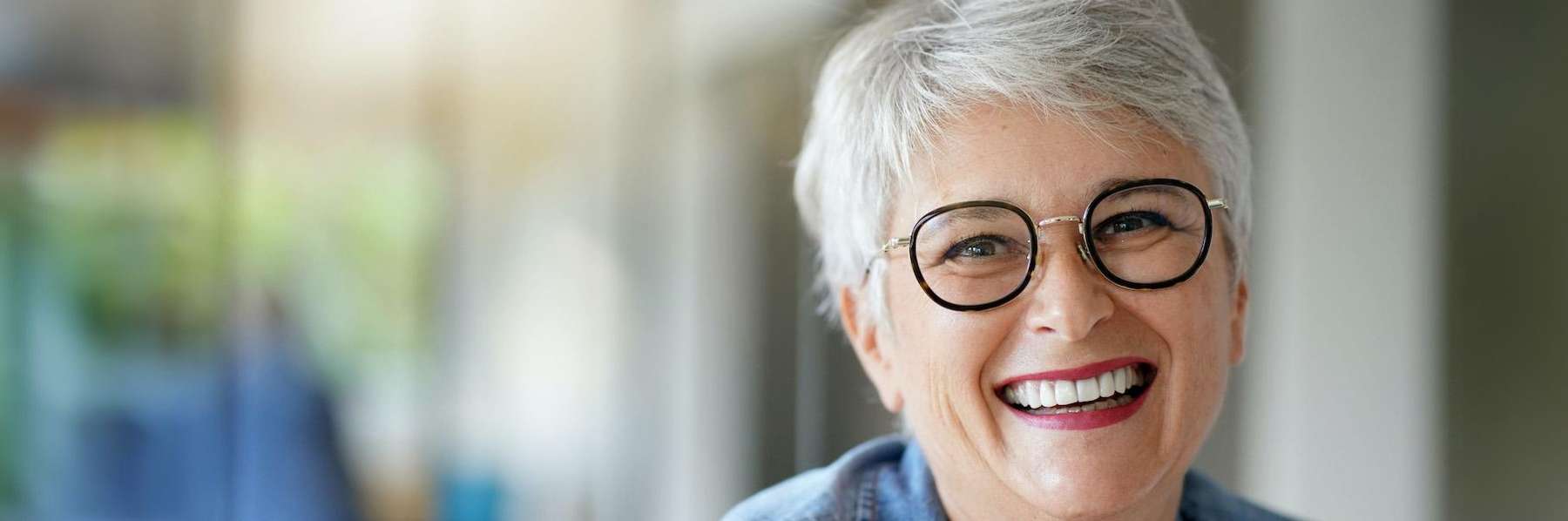 Happy woman smiling brightly after recovering from a tooth extraction