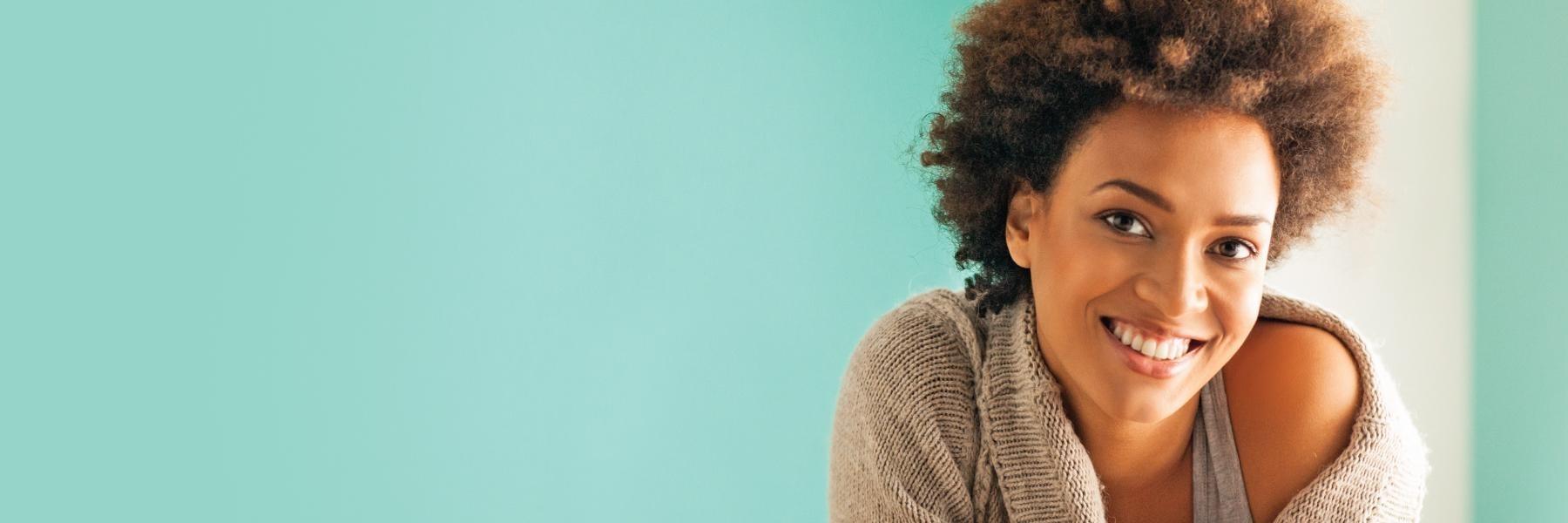 woman with curly hair smiling l dentist garland