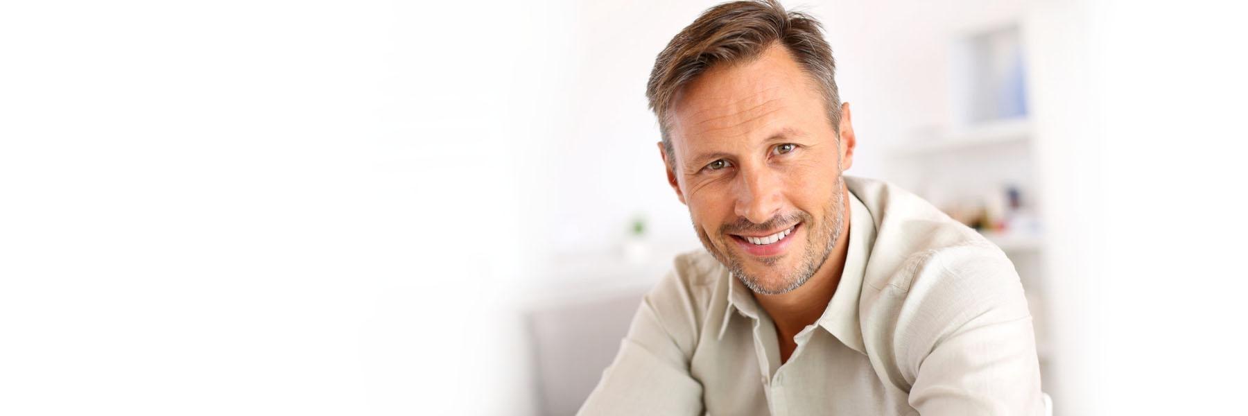 man with facial hair smiling l veneers in garland tx