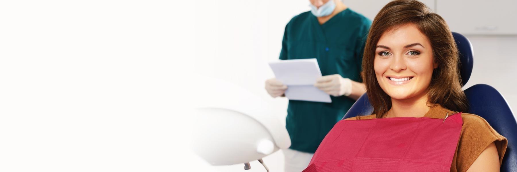 Woman smiling in dental exam chair l dentist garland tx
