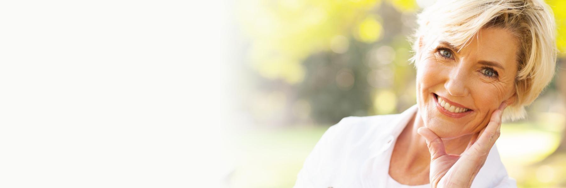 Older woman smiling outside l tooth extractions in garland tx